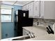 Kitchen boasts black appliances and gray countertops at 11485 Oakhurst Rd # 221, Largo, FL 33774