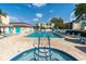 Community pool and spa with lounge chairs for relaxing at 11485 Oakhurst Rd # 221, Largo, FL 33774