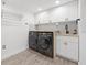 Modern laundry room with white cabinets, a butcher block countertop, and black appliances at 960 Starkey Rd # 3406, Largo, FL 33771