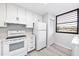 Modern white kitchen with stainless steel appliances at 220 Pineneedle Dr # 220, Bradenton, FL 34210