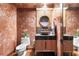 Powder room features a dark brown vanity, round mirror, and Venetian plaster walls at 3087, 3075 Cherry Ln, Clearwater, FL 33759