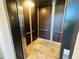 Clean and modern elevator interior with wood paneling at 3087, 3075 Cherry Ln, Clearwater, FL 33759