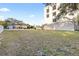 Vacant lot with grassy area, next to a multi-story home at 3087, 3075 Cherry Ln, Clearwater, FL 33759