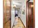 Long hallway with tile floors and elegant wood doors at 3087, 3075 Cherry Ln, Clearwater, FL 33759