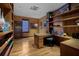 Spacious home office with built-in shelving and hardwood floors at 3087, 3075 Cherry Ln, Clearwater, FL 33759