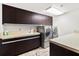 Modern laundry room with dark cabinetry and appliances at 3087, 3075 Cherry Ln, Clearwater, FL 33759