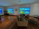 Comfortable living room with ocean view screens and hardwood floors at 3087, 3075 Cherry Ln, Clearwater, FL 33759