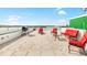 Relaxing rooftop deck with red patio furniture at 3087, 3075 Cherry Ln, Clearwater, FL 33759