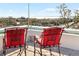 Two red chairs on rooftop deck overlooking the water at 3087, 3075 Cherry Ln, Clearwater, FL 33759