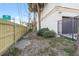 Side yard with a wooden fence and access to the garage at 3087, 3075 Cherry Ln, Clearwater, FL 33759