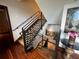 Elegant staircase with metal railing and hardwood floors at 3087, 3075 Cherry Ln, Clearwater, FL 33759