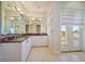 Elegant bathroom with a large vanity, granite countertops, and private balcony at 42 Midway Is, Clearwater, FL 33767