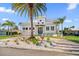 Luxury waterfront home with modern design, circular driveway & lush landscaping at 42 Midway Is, Clearwater, FL 33767