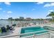 Stunning pool and deck overlooking the water with lounge chairs and spa at 42 Midway Is, Clearwater, FL 33767