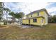 Large yellow two-story house with a spacious yard at 553 Division St, Tarpon Springs, FL 34689