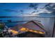 Panoramic aerial view of a waterfront property at twilight, showcasing stunning water views at 634 Edgewater Dr # 644, Dunedin, FL 34698