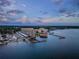 Aerial view of the waterfront condo community with boat slips, docks, and lush landscaping at 634 Edgewater Dr # 644, Dunedin, FL 34698