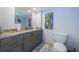 Updated bathroom with granite countertop, grey vanity, and decorative artwork at 634 Edgewater Dr # 644, Dunedin, FL 34698