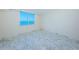 Bright, vacant bedroom with a water view and marble tile flooring at 634 Edgewater Dr # 644, Dunedin, FL 34698