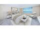 Serene bedroom with a water view, ceiling fan, and comfortable furnishings at 634 Edgewater Dr # 644, Dunedin, FL 34698