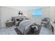 Lovely staged bedroom with a water view, a sitting area, and stylish decor at 634 Edgewater Dr # 644, Dunedin, FL 34698