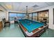 Game room featuring a billiards table and large windows with water views at 634 Edgewater Dr # 644, Dunedin, FL 34698