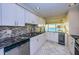 Updated kitchen with stainless steel appliances, wine cooler, and granite countertops at 634 Edgewater Dr # 644, Dunedin, FL 34698