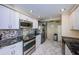 Kitchen featuring stainless steel appliances, sleek countertops, mosaic backsplash, and marble flooring at 634 Edgewater Dr # 644, Dunedin, FL 34698