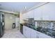 Kitchen featuring stainless steel appliances, sleek countertops, mosaic backsplash, and marble flooring at 634 Edgewater Dr # 644, Dunedin, FL 34698