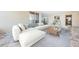 Bright, spacious living room with modern furniture, marble floors, and access to the ocean-view balcony at 634 Edgewater Dr # 644, Dunedin, FL 34698