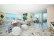 Bright living room features large windows offering beautiful ocean views, with neutral modern decor at 634 Edgewater Dr # 644, Dunedin, FL 34698