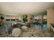 Light-filled living room with marble floors, neutral furniture, and floor-to-ceiling windows with ocean views at 634 Edgewater Dr # 644, Dunedin, FL 34698