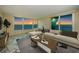 Comfortable living room with a large sectional sofa and sliding doors opening to scenic ocean views at 634 Edgewater Dr # 644, Dunedin, FL 34698