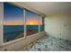 Breathtaking sunset views of the ocean from a room with large windows and marble floors at 634 Edgewater Dr # 644, Dunedin, FL 34698