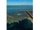 Beautiful aerial shot of the pier extending over clear, shallow waters at 634 Edgewater Dr # 644, Dunedin, FL 34698