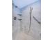 Contemporary shower with gray tile, a rainfall showerhead, and built-in shelving at 634 Edgewater Dr # 644, Dunedin, FL 34698