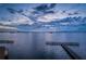 Scenic water view with a long dock extending into the calm water at twilight at 634 Edgewater Dr # 644, Dunedin, FL 34698