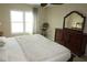 Bright bedroom with a dresser, large bed, and window offering natural light at 4900 Brittany S Dr # 1303, St Petersburg, FL 33715