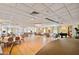 Large community room with tables, chairs, and a piano at 4900 Brittany S Dr # 1303, St Petersburg, FL 33715