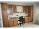 Home office with built-in wooden desk and cabinets at 4900 Brittany S Dr # 1303, St Petersburg, FL 33715