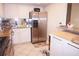 Kitchen with stainless steel refrigerator and granite countertops at 4900 Brittany S Dr # 1303, St Petersburg, FL 33715