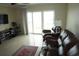 Living room with sliding doors and leather furniture at 4900 Brittany S Dr # 1303, St Petersburg, FL 33715