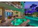 Expansive pool and spa with outdoor seating at night at 231 Midway Is, Clearwater Beach, FL 33767