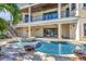 Luxury pool and spa area with fire pit and expansive patio at 231 Midway Is, Clearwater Beach, FL 33767