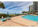 Stunning pool area with ocean views and lounge chairs at 1540 Gulf Blvd # 806, Clearwater, FL 33767