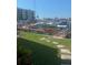 Private boat dock offering waterfront access and serene views of the building, with an adjacent lawn area at 240 Windward Psge # 504, Clearwater, FL 33767