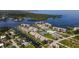 Aerial view of waterfront community with buildings, docks, and tennis court at 8210 Aquila St # 223, Port Richey, FL 34668