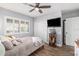 Spacious bedroom with a queen bed, double closets, and wood flooring at 8210 Aquila St # 223, Port Richey, FL 34668