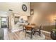 Open concept dining area with a round wooden table and chairs at 8210 Aquila St # 223, Port Richey, FL 34668