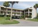 Condo building with parking and lush landscaping at 8210 Aquila St # 223, Port Richey, FL 34668
